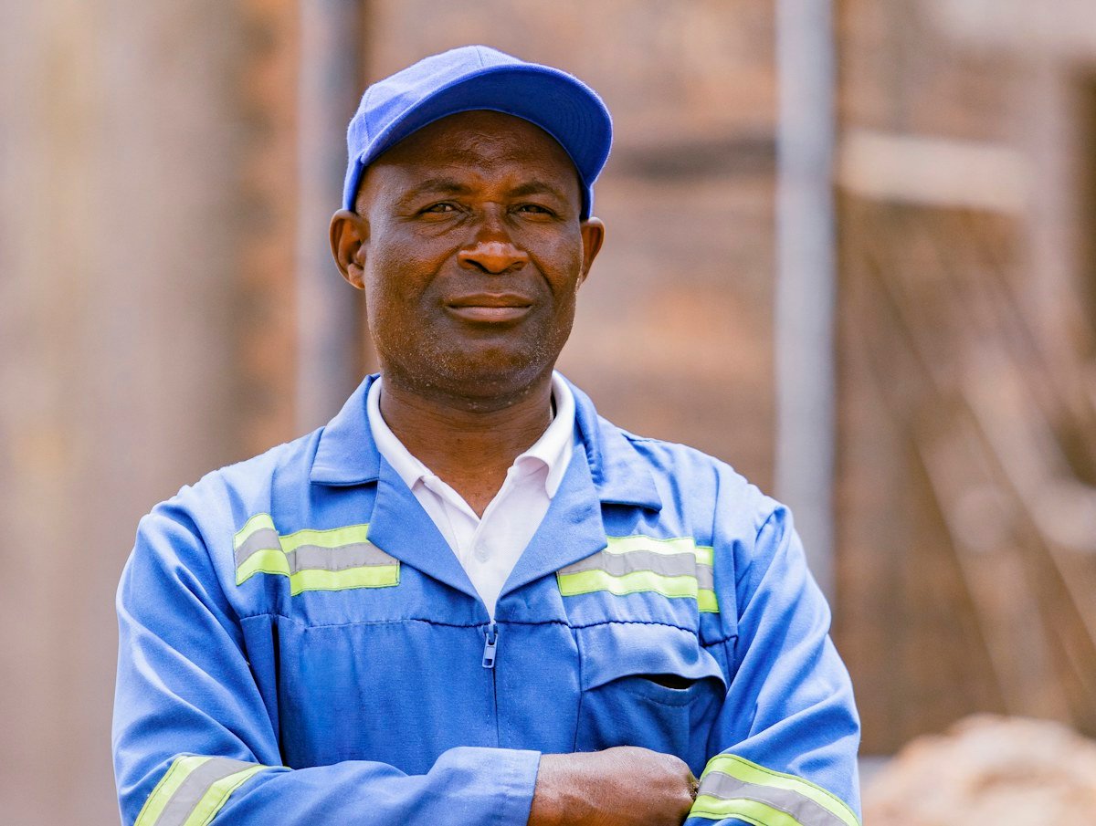 Friendly FlowGuard Plumbing technician in a blue uniform ready to help